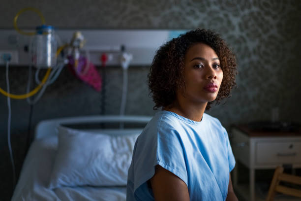 istock Thoughtful female patient sitting at hospital 921583814