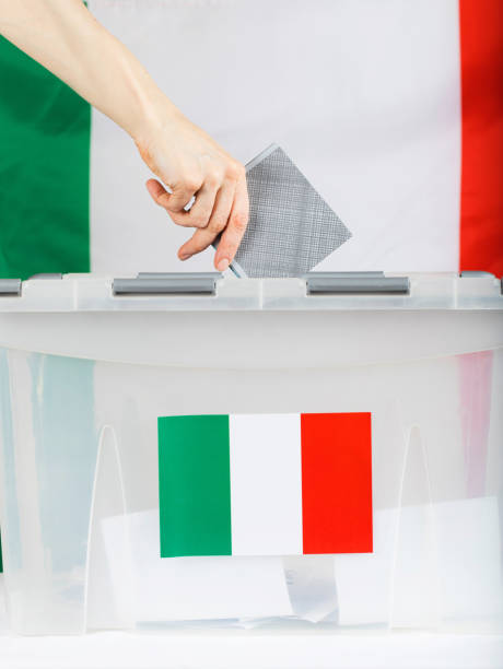 istock Female hand keeps ballot over ballot box. 921583838