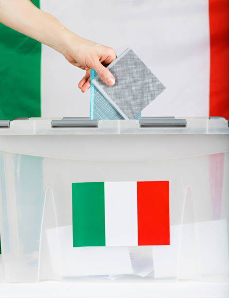 istock Female hand keeps ballot over ballot box. 921583840