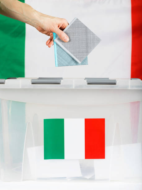 istock Female hand keeps ballot over ballot box. 921583844