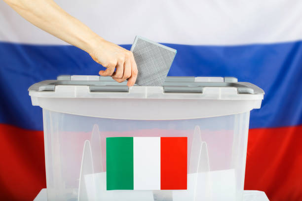 istock Female hand keeps ballot over ballot box. 921583866