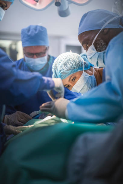 istock Multi-ethnic surgeons operating girl at hospital 921584650