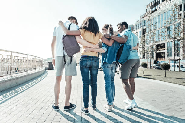 istock Happy nice friends walking together 921584802