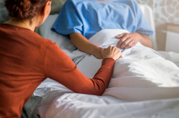 istock Patient sitting with sister in hospital ward 921587314