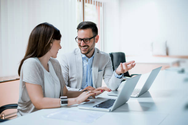 istock Colleagues working together at their desk in the office 921587500