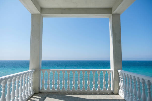 istock White gazebo on the waterfront with seascape view. Close up view 921588376