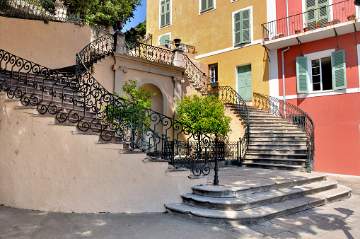 Beautiful staircase on a square of bastia in Corsica in front of colored building
