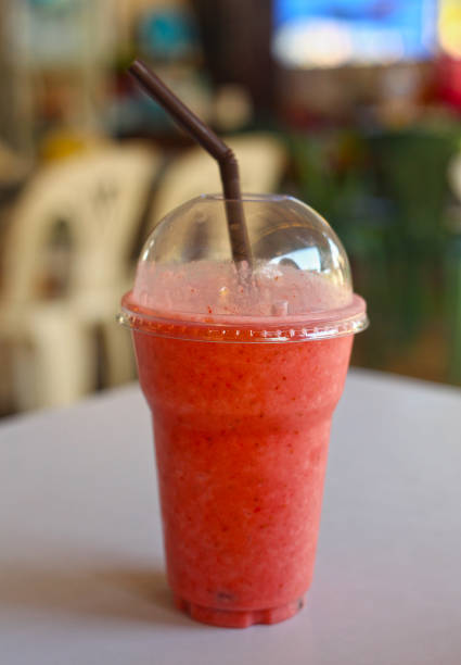 istock Healthy strawberry smoothie inplastic glass with cup 921590624