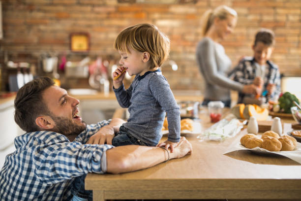 istock Happy father talking to his small son in the kitchen. 921590854
