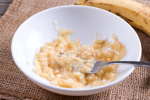 istock Slices of banana in a bowl and fork 921590920