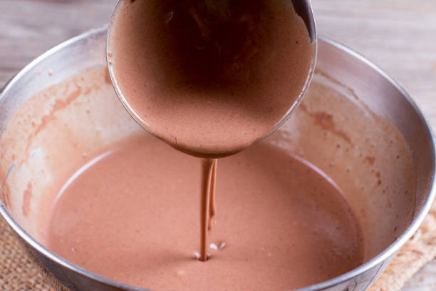 istock Mixing dough for pancakes or cake in bow on the table 921590954