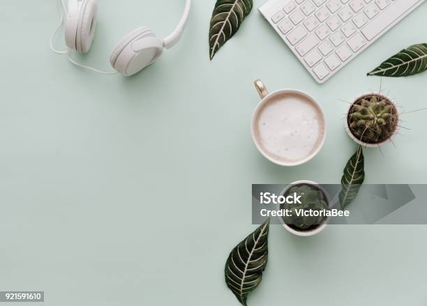 Neutral Minimalist Flat Lay Scene With Coffee Keyboard Headphones And Cactus Stock Photo - Download Image Now