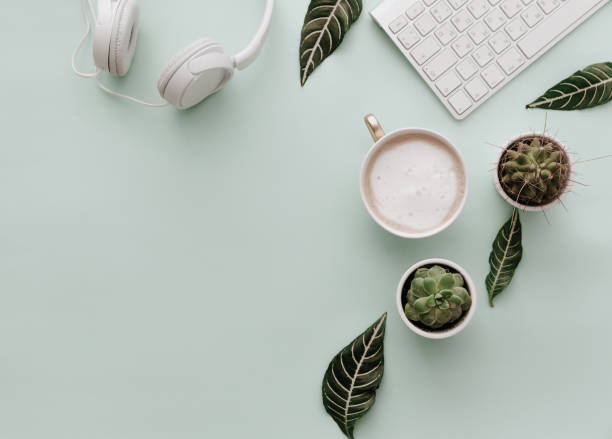 neutral minimalist flat lay scene with coffee, keyboard, headphones and cactus - coffee top view imagens e fotografias de stock