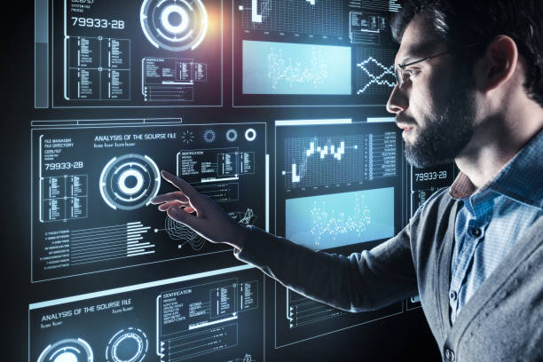 istock Serious man in glasses touching the screen and feeling worried 921591630