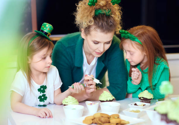 istock Interested children decorating cupcakes with mother 921594156