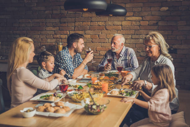 istock Extended family enjoying in dinner time at dining table. 921594190