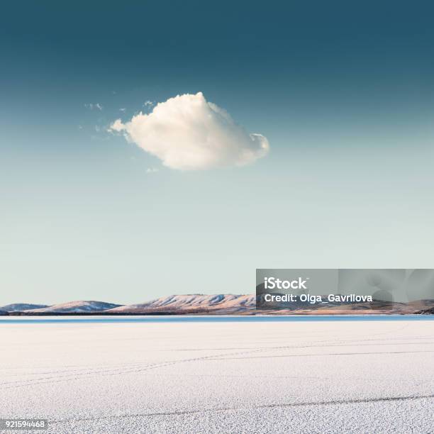 Cloud Over A Frozen Lake Stock Photo - Download Image Now - Landscape - Scenery, Sparse, Scenics - Nature