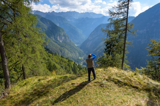 A man taking picture of Mountain View from Vrsic pass/ mountain pass, Julian Alps, Slovenia A man taking picture of Mountain View from Vrsic pass, Julian Alps, Slovenia soca valley stock pictures, royalty-free photos & images