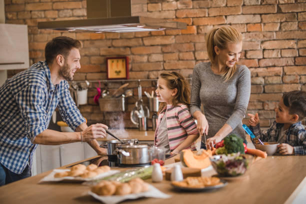istock Young happy family communicating while preparing lunch together. 921594774