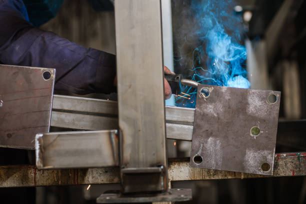 istock Close-up of welder's hands in working process 921601486