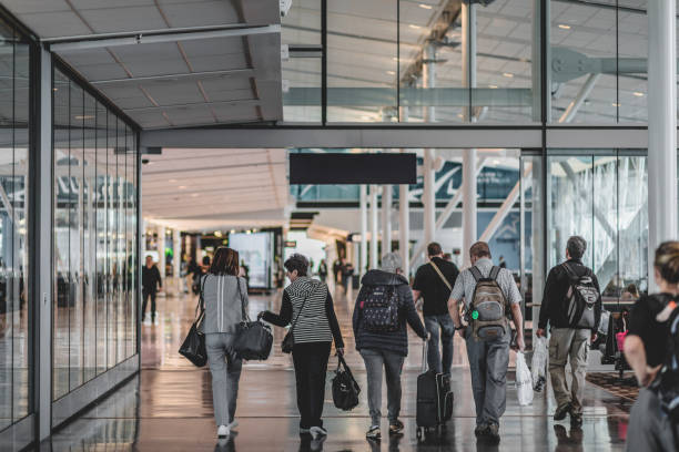 Travelers Walking Inside the Montreal Airport in the International Area stock photo