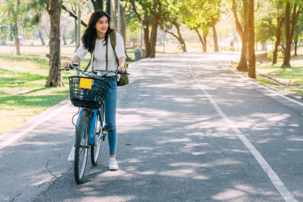 istock Woman with bicycle in the garden 921602062