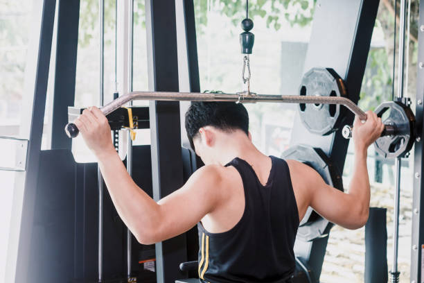 istock Fitness man execute exercise with exercise-machine at the gym 921602148