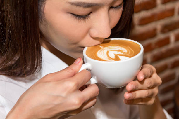 istock Woman drinking coffee at coffee shop 921602304