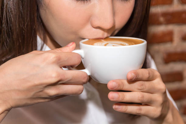 istock Woman drinking coffee at coffee shop 921602314