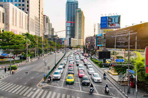 The exclusive district of Sukhumvit, Bangkok, Thailand, seen during a late afternoon in the autumn. Skyscrapers rising and crowded traffic on the streets.