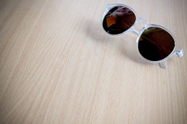 istock sunglasses on wooden table 921604534