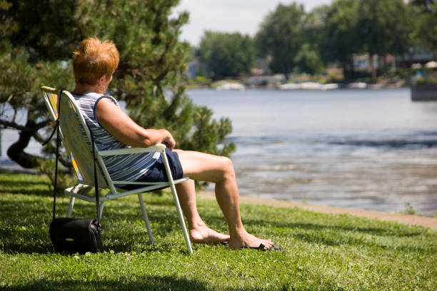istock Woman sitting by a river 92160804