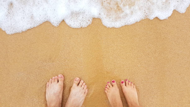 istock feet on the sand beach 921609606