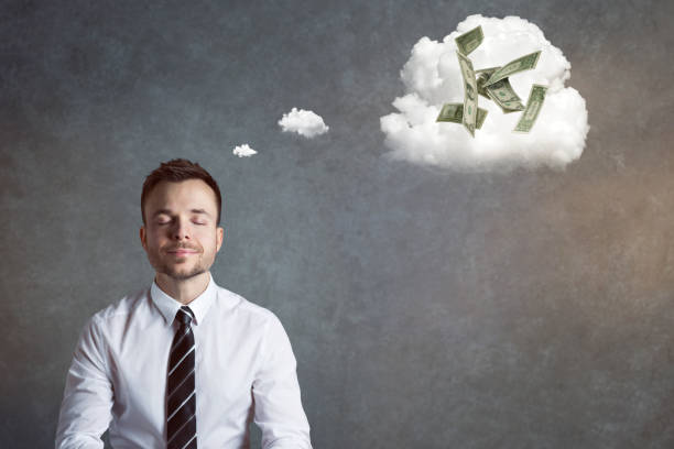 istock Smiling businessman thinking of money 921609752