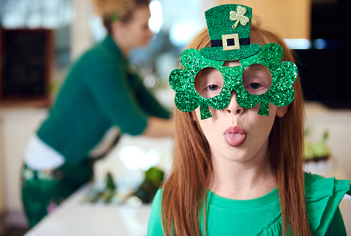 Ratoath, Ireland - March 17, 2010:  Schools girls dressed in Irish colors cheering up at the St Patrick's day parade in an Irish village.