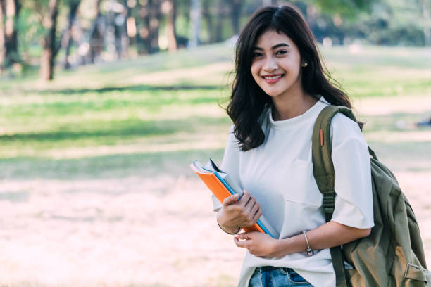 istock Woman students holding notebooks outdoors.Education concept 921617628