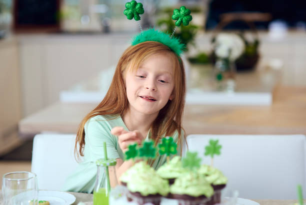istock Cheerful girl reaching for cupcake 921617994