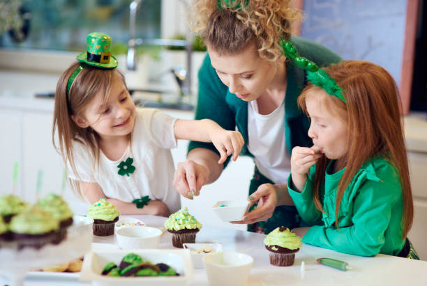 Woman with children decorating cupcakes Woman with children decorating cupcakes decorating a cake photos stock pictures, royalty-free photos & images