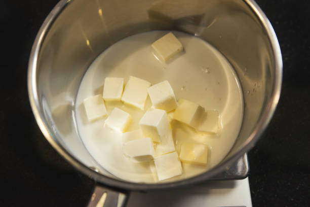 istock Melted fresh butter in a metal pot on kitchen table 921621218