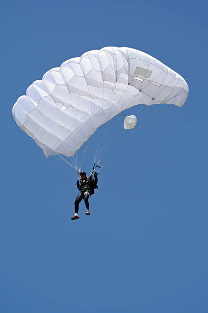 Under the beautiful blue sky Parachutist in air glider hang glider hanging sky stock pictures, royalty-free photos & images