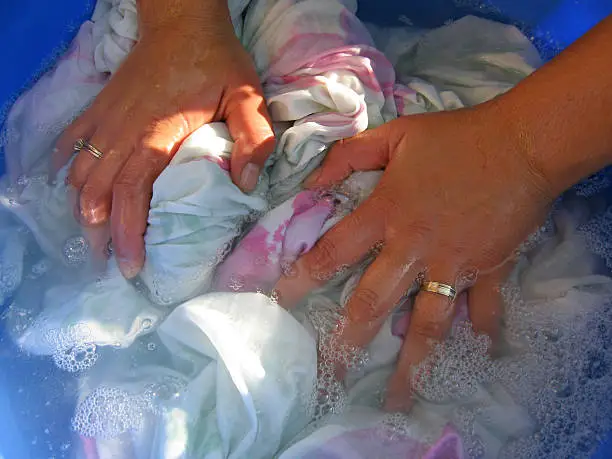 Woman hands washing clothes