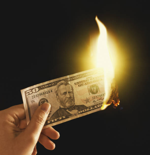 istock Money to burn: hand holds American $50 banknote in flames 921627074