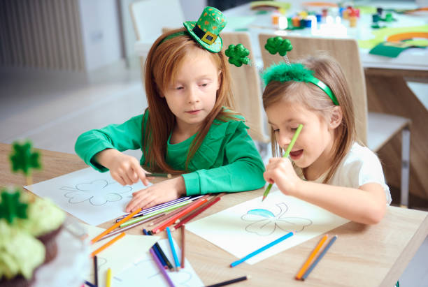 Cheerful siblings coloring different illustrations stock photo