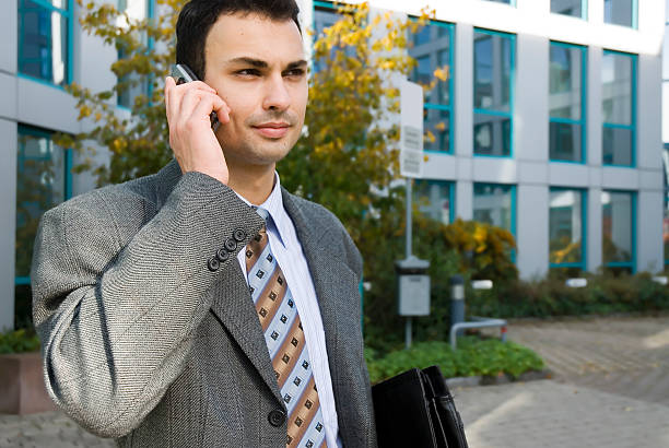 istock young  businessman on a cellphone 92162831