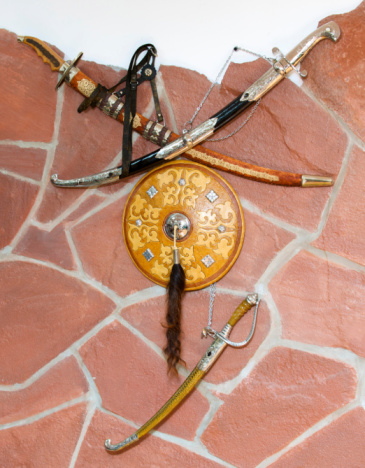 Sword and board of ancient Mongols on a stone wall