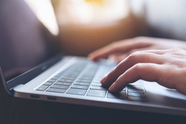 istock Closeup image of hands working and typing on laptop keyboard on the table 921632190