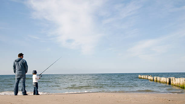 istock A father and son fishing at the beach 92163396