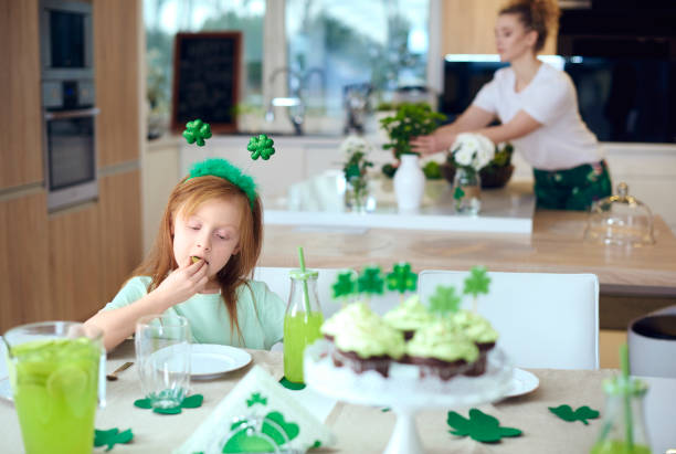 istock Girl eating cookie at table 921634318