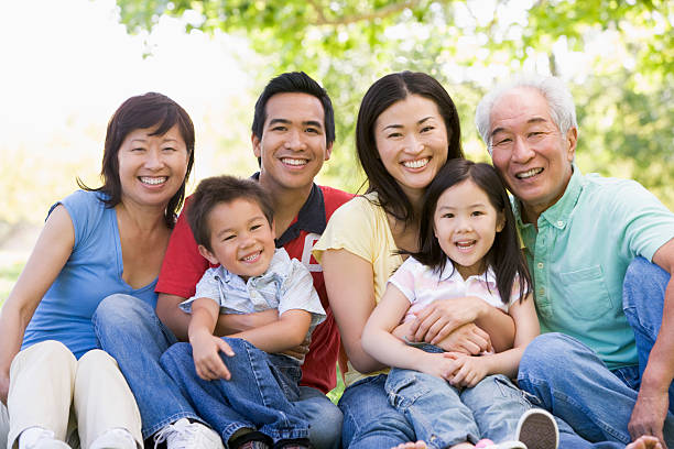 istock Extended family sitting outdoors smiling 92163450