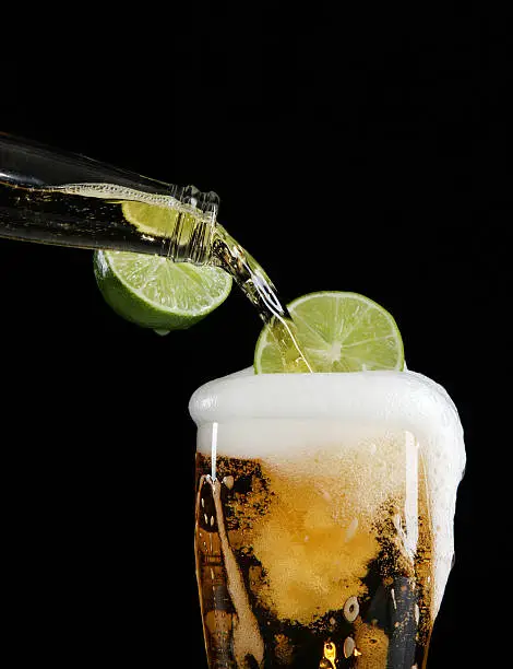 Photo of Pouring beer with lime